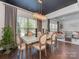 Elegant dining room with modern chandelier, dark ceiling, and views into a cozy living area at 5020 Forest Hills Pl, Fort Mill, SC 29707