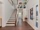 Bright foyer featuring a wooden staircase and elegant hardwood flooring and white door at 5020 Forest Hills Pl, Fort Mill, SC 29707