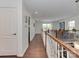 Hallway featuring wood floors and bright lighting, leading to living area at 5020 Forest Hills Pl, Fort Mill, SC 29707
