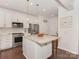 Modern kitchen featuring white cabinetry, stainless steel appliances, a center island, and pendant lighting at 5020 Forest Hills Pl, Fort Mill, SC 29707
