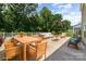 Beautifully staged patio with ample seating and a view of the lush, tree-lined backyard at 5098 Burnwald Ct, Fort Mill, SC 29715