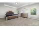 Tranquil bedroom with a trey ceiling, neutral walls, plush carpeting, and traditional furnishings at 5098 Burnwald Ct, Fort Mill, SC 29715