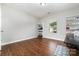 Bright bedroom with hardwood floors, large window, and built-in shelving for storage or display at 5098 Burnwald Ct, Fort Mill, SC 29715