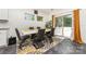 Contemporary dining area with a white table, modern chairs, stylish rug, and sliding glass doors for outdoor access at 5098 Burnwald Ct, Fort Mill, SC 29715