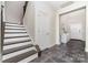 Inviting entryway with staircase, neutral walls, grey tile floors, leading to the front door, and white trim at 5098 Burnwald Ct, Fort Mill, SC 29715