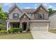 Beautiful two-story home with a stone and brick facade, complemented by a manicured lawn and attached two-car garage at 5098 Burnwald Ct, Fort Mill, SC 29715