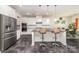 Modern kitchen with white cabinets, stainless steel appliances, gray countertops, and an open view to the dining area at 5098 Burnwald Ct, Fort Mill, SC 29715