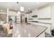 Modern kitchen featuring stainless steel appliances, white cabinets, and a spacious island with seating at 5098 Burnwald Ct, Fort Mill, SC 29715