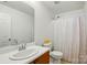 Bright bathroom featuring a vanity with a large mirror and a shower with a patterned curtain at 611 Annalinde Ln, Rock Hill, SC 29732