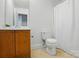 Bathroom featuring a wooden vanity and toilet with white shower curtain at 611 Annalinde Ln, Rock Hill, SC 29732