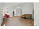 Bright living room with neutral walls, plush carpet, and ample space for seating, ideal for relaxation and entertainment at 611 Annalinde Ln, Rock Hill, SC 29732