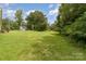 Lush backyard with mature trees and a detached garage at 828 Carver St # 17-19, Shelby, NC 28152