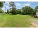 A sprawling backyard with mature trees providing a sense of privacy at 828 Carver St # 17-19, Shelby, NC 28152