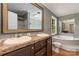 Bathroom vanity with double sinks, garden tub, and framed mirror at 828 Carver St # 17-19, Shelby, NC 28152