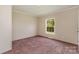 Spacious bedroom offers neutral walls, pink carpet, and a window view at 828 Carver St # 17-19, Shelby, NC 28152
