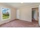 This bedroom has pink carpet, neutral walls, and a bright window at 828 Carver St # 17-19, Shelby, NC 28152