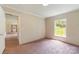 A view of this cozy bedroom featuring pink carpeting and a bright window at 828 Carver St # 17-19, Shelby, NC 28152