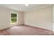 This bedroom features pink carpeting, a large window, and neutral walls at 828 Carver St # 17-19, Shelby, NC 28152
