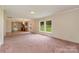 Open living room features a window view and seamless access to the kitchen at 828 Carver St # 17-19, Shelby, NC 28152