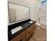 Bathroom showcasing a double sink vanity with black countertop and framed mirrors above at 908 Apex Dr, Albemarle, NC 28001