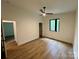 Bright bedroom with sleek ceiling fan, wood-look floor, and modern black trim window at 908 Apex Dr, Albemarle, NC 28001