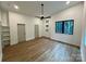 Bright, airy bedroom with luxury vinyl plank flooring, modern fan, and multiple windows at 908 Apex Dr, Albemarle, NC 28001