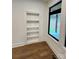 Built-in bookcase with a hidden door and natural light from the nearby window at 908 Apex Dr, Albemarle, NC 28001