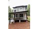 View of a modern two-story house with a covered porch and a gravel driveway at 908 Apex Dr, Albemarle, NC 28001