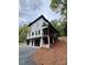 View of a modern two-story house with a covered porch and a gravel driveway at 908 Apex Dr, Albemarle, NC 28001
