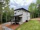 View of a modern two-story house with a covered porch and a gravel driveway at 908 Apex Dr, Albemarle, NC 28001