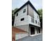 Modern two-story home showcasing white siding, dark window trim, and a two-car garage at 908 Apex Dr, Albemarle, NC 28001