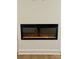 Modern electric fireplace set into a white wall between two large windows in a well-lit room at 908 Apex Dr, Albemarle, NC 28001