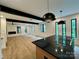 Kitchen and living area with an island cooktop, modern design, and plenty of natural light at 908 Apex Dr, Albemarle, NC 28001