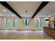 Open concept living room featuring exposed beams, modern lighting, and large windows at 908 Apex Dr, Albemarle, NC 28001