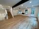 Spacious living area with a staircase, modern fireplace, and plenty of natural light at 908 Apex Dr, Albemarle, NC 28001