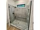 Modern shower featuring elegant marble-style tiling, glass enclosure, and black fixtures at 908 Apex Dr, Albemarle, NC 28001