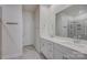 Bathroom with dual sinks, white cabinets, and a large mirror over the vanity at 9226 Dunwich Dr, Gastonia, NC 28056