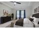 Comfortable bedroom with a fan, dresser, blue curtains, and a padded bench with a decorative brown bedspread at 9226 Dunwich Dr, Gastonia, NC 28056