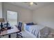 Bedroom with neutral walls, carpeted floors, window, desk, and a twin bed at 9226 Dunwich Dr, Gastonia, NC 28056