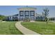 Community clubhouse with classic architectural details, columns, and landscaped grounds at 9226 Dunwich Dr, Gastonia, NC 28056