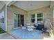 Covered patio featuring brick accents, sliding glass doors, a small seating area, and a fire pit at 9226 Dunwich Dr, Gastonia, NC 28056