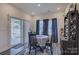 Bright dining area with sliding glass doors to the backyard and a decorative area rug at 9226 Dunwich Dr, Gastonia, NC 28056