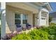 Inviting front porch with seating area, columns, and lush landscaping at 9226 Dunwich Dr, Gastonia, NC 28056