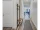Hallway with hardwood floors, coat rack, white doors, and view to living area at 9226 Dunwich Dr, Gastonia, NC 28056