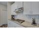 Close-up of kitchen features including stainless steel range hood, gas cooktop, and white cabinets at 9226 Dunwich Dr, Gastonia, NC 28056