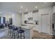 Stylish kitchen with white cabinetry, granite island with seating, and stainless steel appliances at 9226 Dunwich Dr, Gastonia, NC 28056