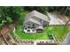 Aerial view of a home showcasing lush landscaping, a backyard patio, a screened porch, and a private driveway at 9423 Man O War Rd, Fort Mill, SC 29707