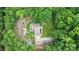 Stunning aerial view of private home surrounded by lush, mature trees and landscaped grounds at 9423 Man O War Rd, Fort Mill, SC 29707