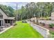 Landscaped backyard with a stone patio, outdoor seating, and mature trees for relaxing and enjoying nature at 9423 Man O War Rd, Fort Mill, SC 29707