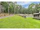 Lush backyard featuring terraced landscaping, a walking path, and a privacy fence, creating a peaceful retreat at 9423 Man O War Rd, Fort Mill, SC 29707